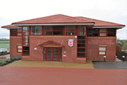 Photograph depicting the frontage of a modern red brick building