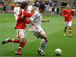 Action Photograph of England and Welsh players tackling for the ball at Molinuex