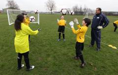 Youngsters being coached football